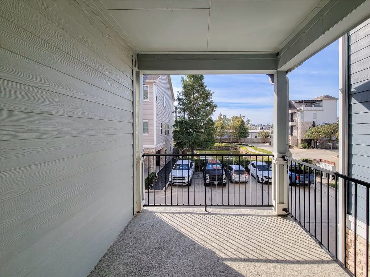 Enjoy a private balcony with a view of the parking area, offering a blend of privacy and convenience in a cozy outdoor space.