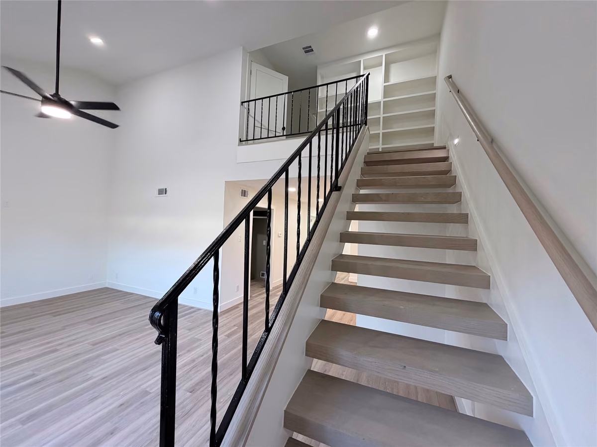 Stairs have been reimagined to be modern, open and a raised stair rail for extra security.