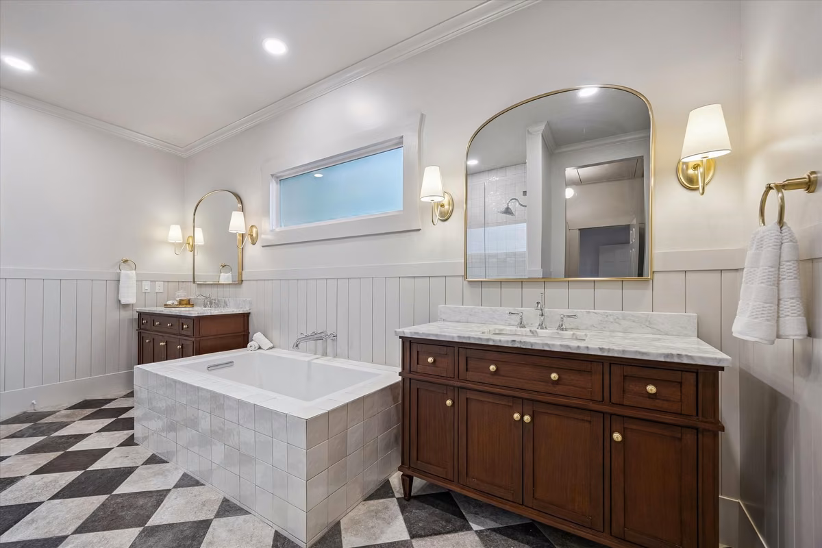 Another view of the dual vanities with designer lighting & soaking tub.