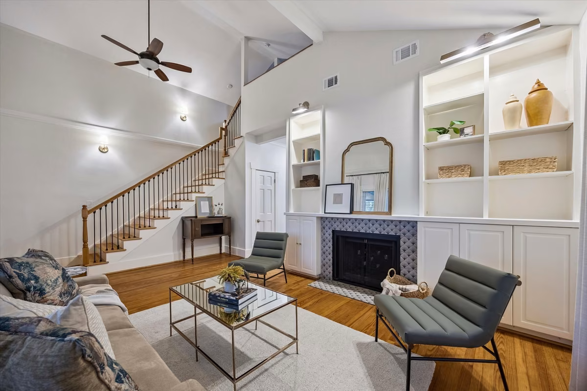 Beautiful living room featuring high ceilings; fireplace; and built-ins.
