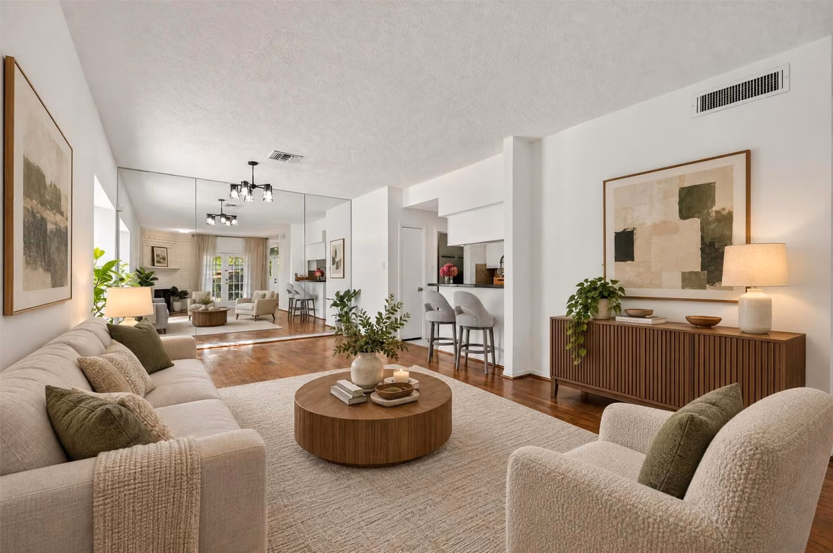An alternate view of the living room showcasing the flow toward the dining area and kitchen. Virtually staged.