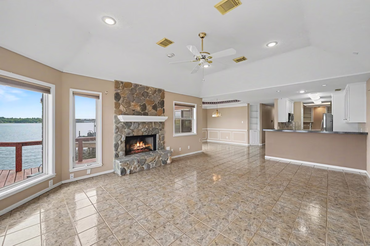 Living Area with focal point Fire Place  surrounded by windows with a view.