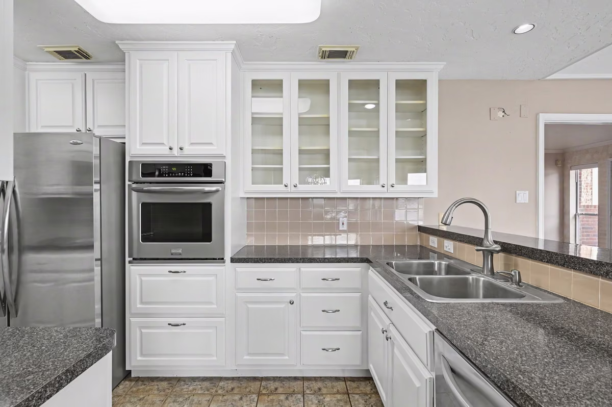 Freshly painted cabinets with stainless appliances