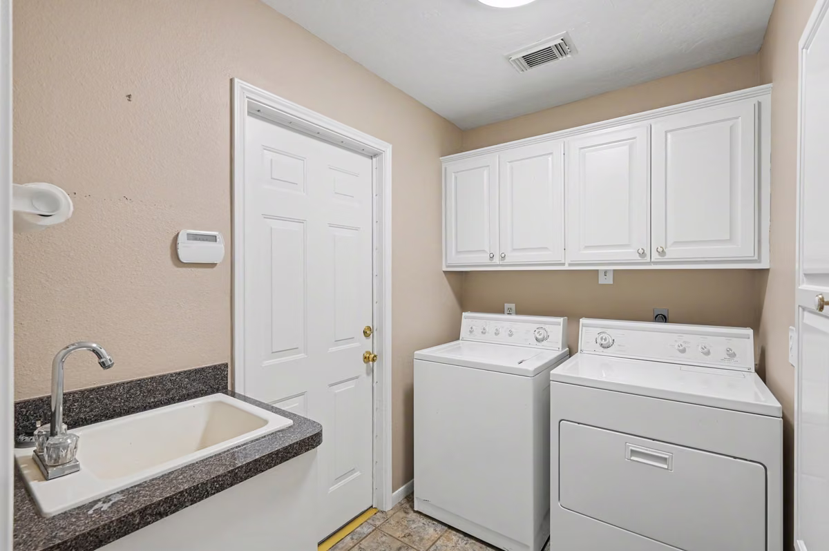 Utility Room with Utility Sink, door leads to garage.