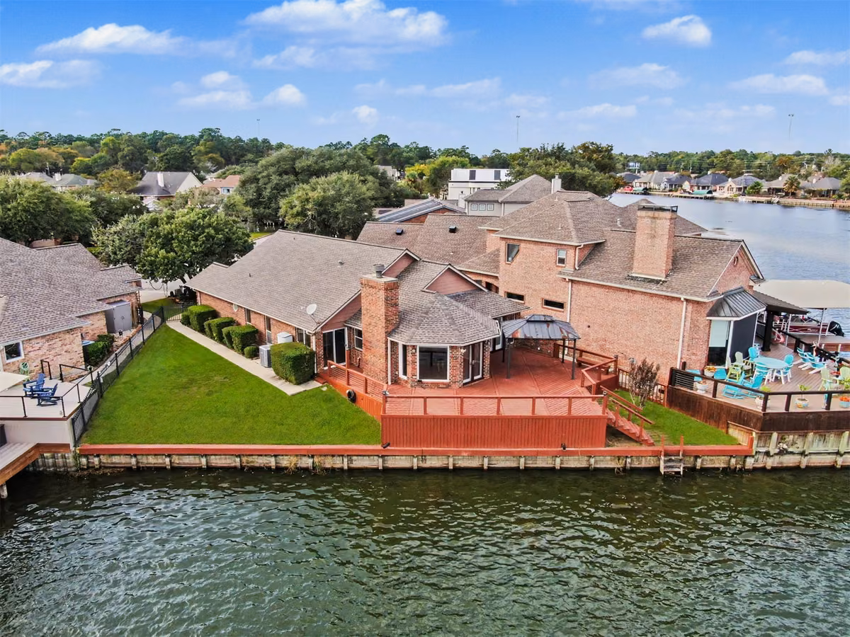 Aerial view highlighting the lakefront home.