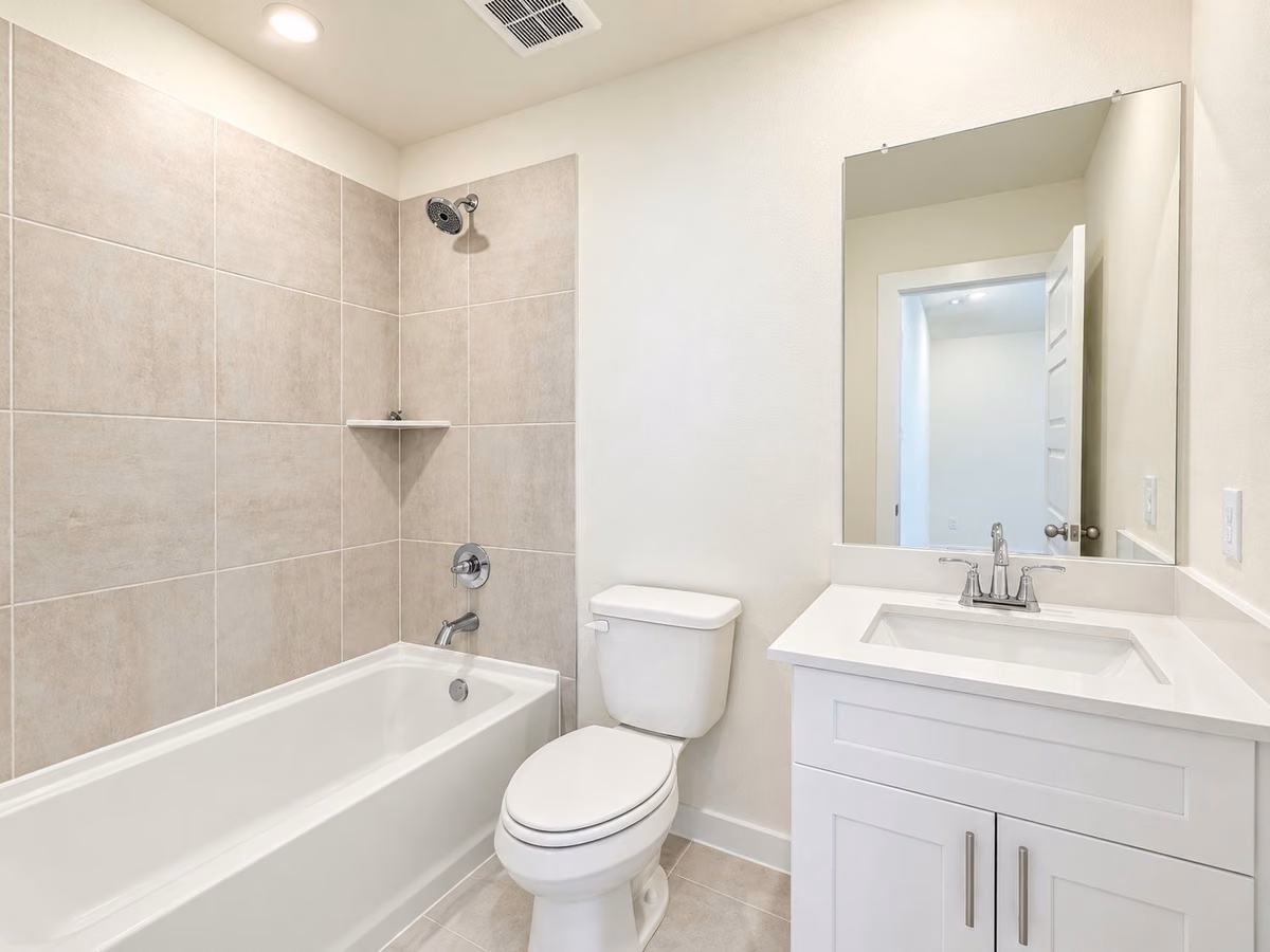 Modern bathroom featuring a vanity and spacious shower/bathtub combo