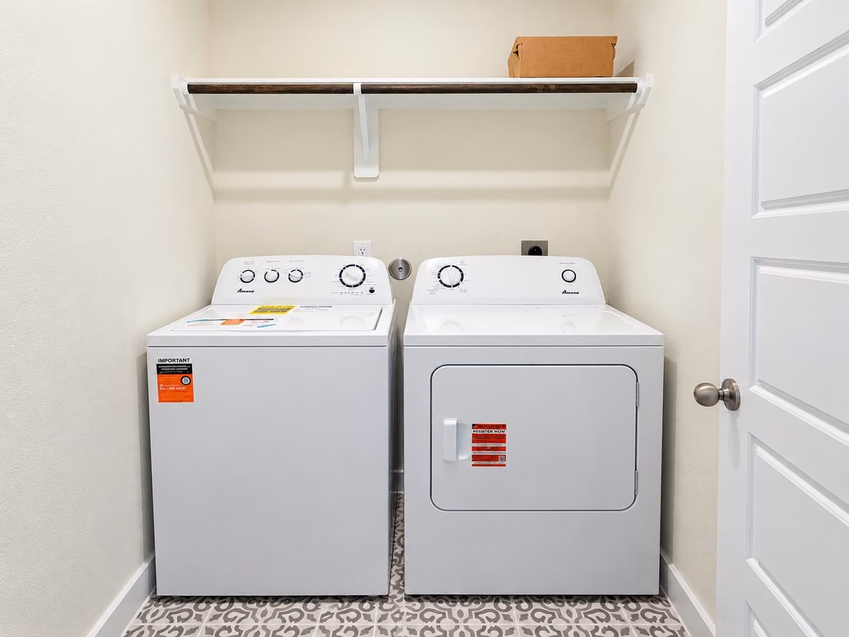 Convenient laundry room with a built-in shelf for storage