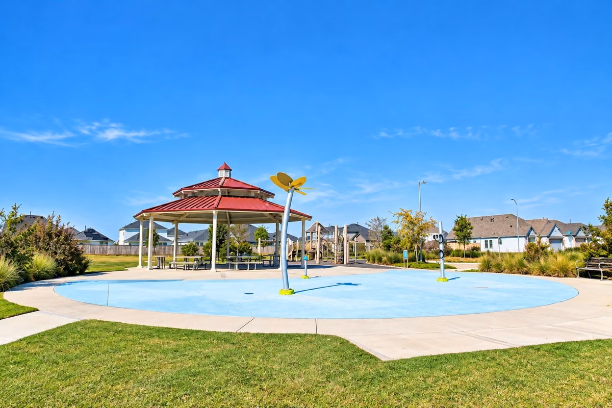 Community park offering a spacious gazebo and a fun splash pad, perfect for family gatherings and outdoor enjoyment.
